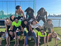 Trainees in the department of Ob/Gyn at Columbia form a human pyramid kneeling on each other's shoulders.